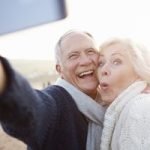 Older couple smile for the camera after getting permanent dentures in Shavano Park.