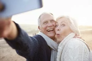 Smiling older couple show off their tooth crowns near Shavano Park.